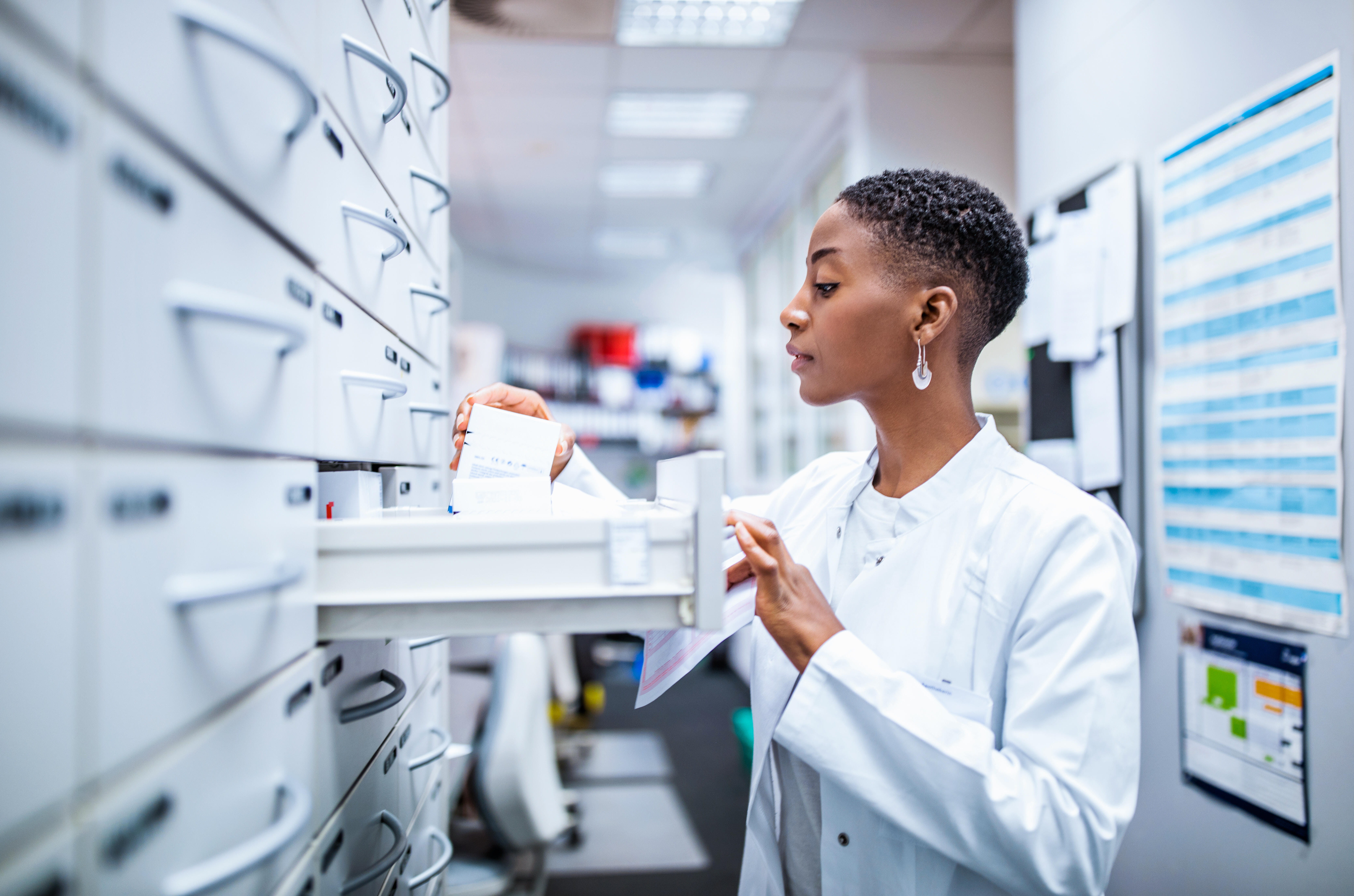 Medical professional sorting through files and prescriptions