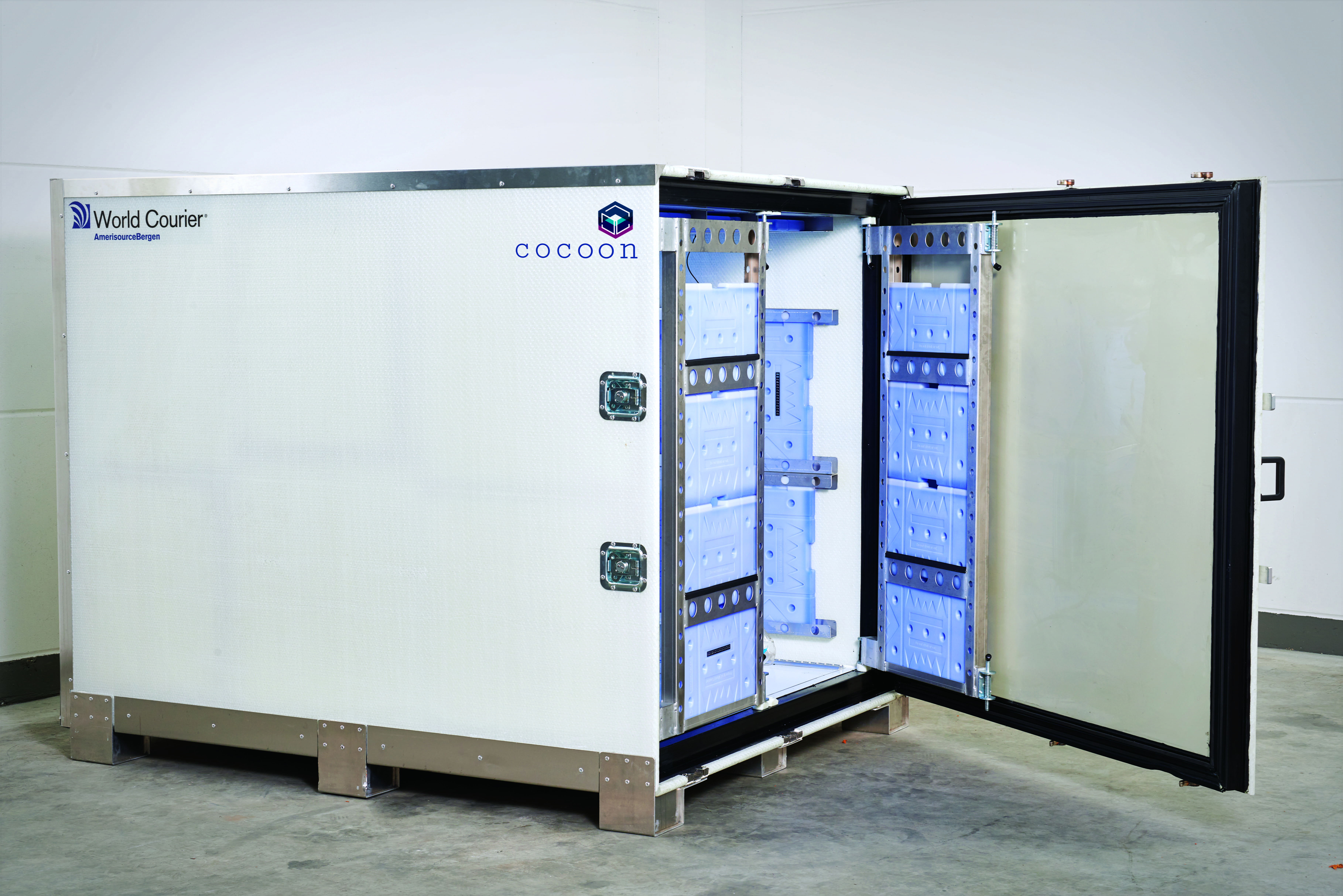 A cocoon shipping unit sits with its door open. Cooling gel packs are visible on the internal frame.