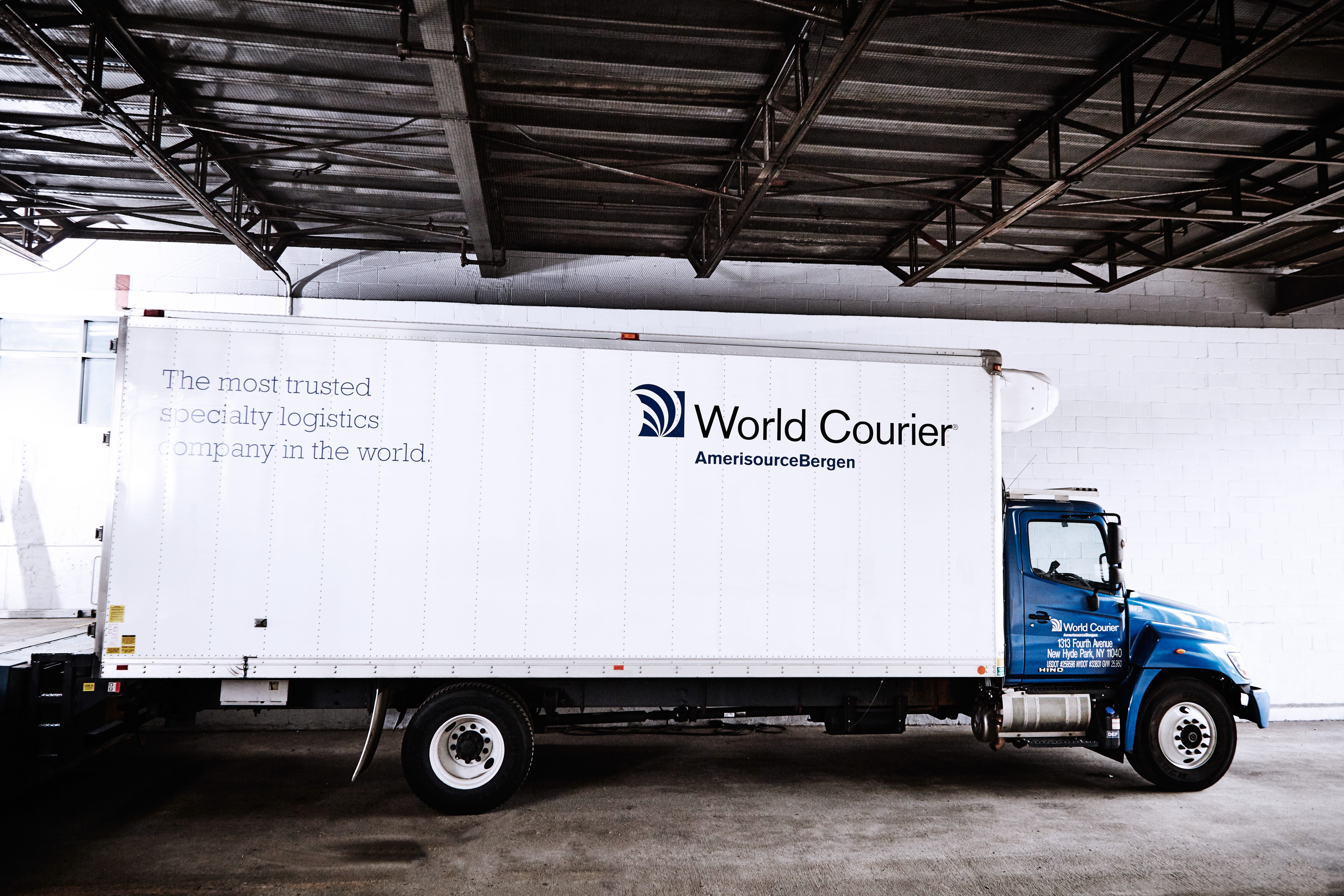 A large World Courier truck, or lorry, parked at a loading dock.